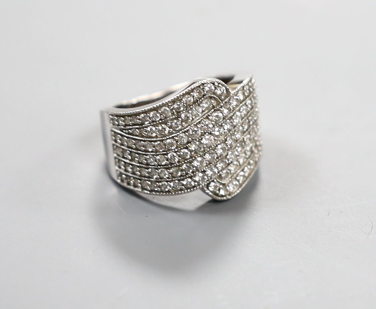 A modern 18ct white gold and pave set diamond dress ring, size O, gross 8.4 grams